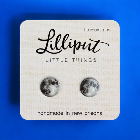Lilliput Little Things Handmade Moon Earrings on blue background Front View