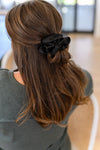Woman wearing black silk hair scrunchie